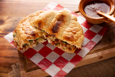 Suadero cake. Torta in Mexico is a type of sandwich that is generally made with a bread called Telera. Suadero, fried and minced meat widely used in the typical Mexican street tacos.の写真素材