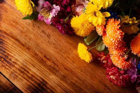 Colorful spring flowers corner border on wooden background. Decoration floral pattern, springtime, Easter, Birthday, Happy Womens Day, Mothers Day. Copy space for your message.の写真素材