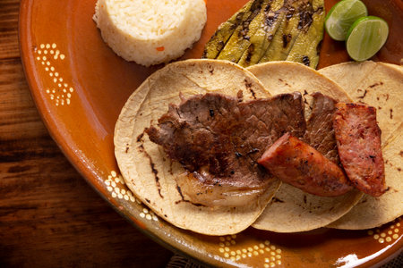 Roast meat tacos with Chorizo. Very popular dish in northern Mexico, also called Carne Asada, Asado, Discada or Parrillada, is a cooking technique in which food is exposed to the heat of the embers.の写真素材