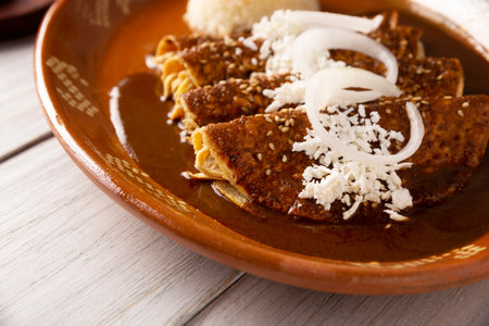 Chicken enmoladas. Also known as mole poblano enchiladas, they are a typical Mexican dish that is very popular in Mexico and the rest of the world.の写真素材