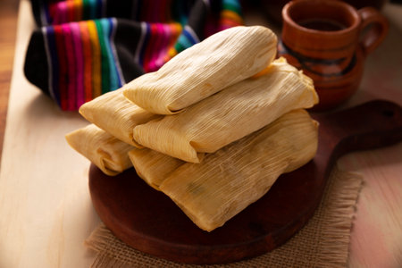 Tamales. Prehispanic dish typical of Mexico and some Latin American countries. Corn dough wrapped in corn leaves. The tamales are steamed.の写真素材