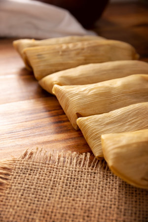 Tamales. Prehispanic dish typical of Mexico and some Latin American countries. Corn dough wrapped in corn leaves. The tamales are steamed.の写真素材