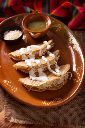 Potato quesadillas. Fried quesadillas made with corn tortillas, they can be filled with any dish or ingredient, such as meat, potato or fish such as marlin or tuna, popular during the Lenten season.の写真素材