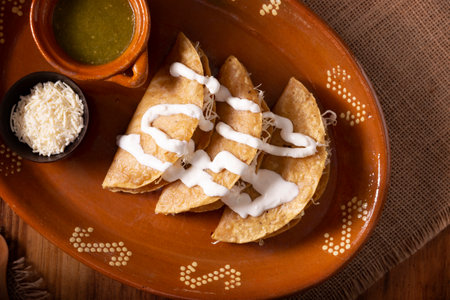 Potato quesadillas. Fried quesadillas made with corn tortillas, they can be filled with any dish or ingredient, such as meat, potato or fish such as marlin or tuna, popular during the Lenten season.の写真素材