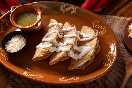 Potato quesadillas. Fried quesadillas made with corn tortillas, they can be filled with any dish or ingredient, such as meat, potato or fish such as marlin or tuna, popular during the Lenten season.の写真素材