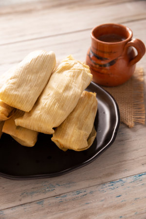 Tamales. Prehispanic dish typical of Mexico and some Latin American countries. Corn dough wrapped in corn leaves. The tamales are steamed.の写真素材
