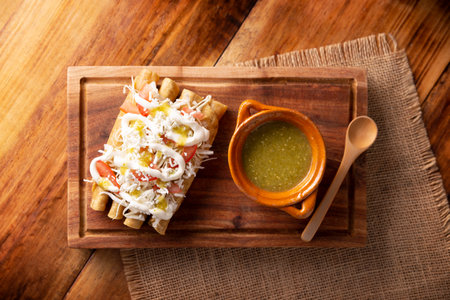 Golden tacos. Mexican dish also known as Flautas, consists of a rolled corn tortilla with some filling, commonly chicken or beef or vegetarian options such as potatoes.の写真素材