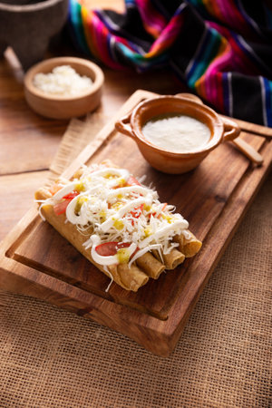 Golden tacos. Mexican dish also known as Flautas, consists of a rolled corn tortilla with some filling, commonly chicken or beef or vegetarian options such as potatoes.の写真素材