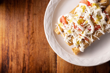 Golden tacos. Mexican dish also known as Flautas, consists of a rolled corn tortilla with some filling, commonly chicken or beef or vegetarian options such as potatoes.の写真素材