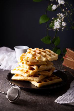 Pile of Fresh Homemade soft waffles served on dark plate.の写真素材