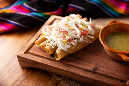 Golden tacos. Mexican dish also known as Flautas, consists of a rolled corn tortilla with some filling, commonly chicken or beef or vegetarian options such as potatoes.の写真素材