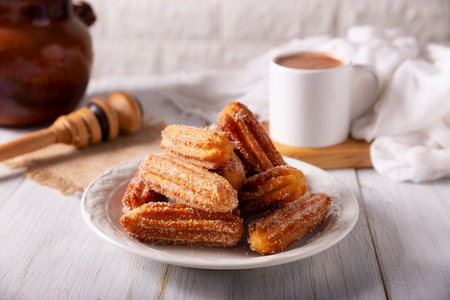 Churros. Fried wheat flour dough, a very popular sweet snack in Spain, Mexico and other countries where it is customary to eat them for breakfast or snack accompanied by hot chocolate or coffee.の写真素材