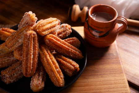 Churros. Fried wheat flour dough, a very popular sweet snack in Spain, Mexico and other countries where it is customary to eat them for breakfast or snack accompanied by hot chocolate or coffee.の写真素材