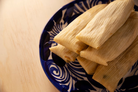 Tamales. Prehispanic dish typical of Mexico and some Latin American countries. Corn dough wrapped in corn leaves. The tamales are steamed.の写真素材