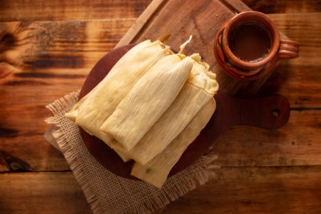 Tamales. Prehispanic dish typical of Mexico and some Latin American countries. Corn dough wrapped in corn leaves. The tamales are steamed.の写真素材