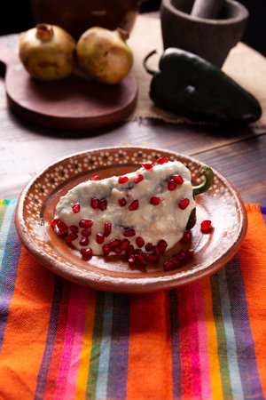 Chiles en Nogada, Typical dish from Mexico. Prepared with poblano chili stuffed with meat and fruits and topped with a walnut sauce. Named as the quintessential Mexican dish for national holidays.の写真素材