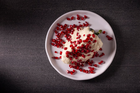 Chiles en Nogada, Typical dish from Mexico. Prepared with poblano chili stuffed with meat and fruits and topped with a walnut sauce. Named as the quintessential Mexican dish for national holidays.の写真素材