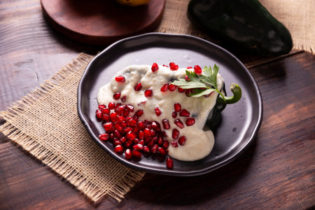 Chiles en Nogada, Typical dish from Mexico. Prepared with poblano chili stuffed with meat and fruits and topped with a walnut sauce. Named as the quintessential Mexican dish for national holidays.の写真素材