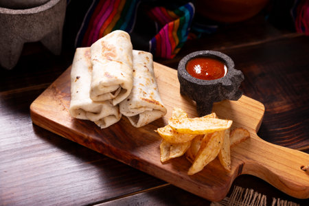 Burritos. Wrapped wheat flour tortilla, can be filled with various ingredients such as scrambled eggs or minced meat, beans and vegetables, a very popular dish in Mexico and the southern USA.の写真素材