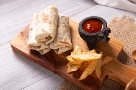 Burritos. Wrapped wheat flour tortilla, can be filled with various ingredients such as scrambled eggs or minced meat, beans and vegetables, a very popular dish in Mexico and the southern USA.の写真素材