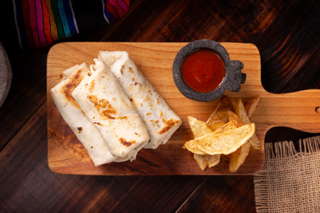 Burritos. Wrapped wheat flour tortilla, can be filled with various ingredients such as scrambled eggs or minced meat, beans and vegetables, a very popular dish in Mexico and the southern USA.の写真素材