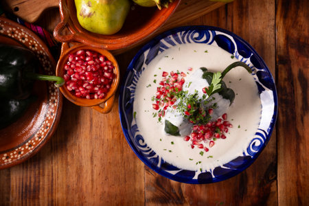 Chiles en Nogada, Typical dish from Mexico. Prepared with poblano chili stuffed with meat and fruits and topped with a walnut sauce. Named as the quintessential Mexican dish for national holidays.の写真素材