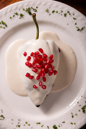 Chiles en Nogada, Typical dish from Mexico. Prepared with poblano chili stuffed with meat and fruits and topped with a walnut sauce. Named as the quintessential Mexican dish for national holidays.の写真素材