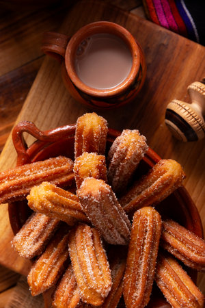 Churros. Fried wheat flour dough, a very popular sweet snack in Spain, Mexico and other countries where it is customary to eat them for breakfast or snack accompanied by hot chocolate or coffee.の写真素材