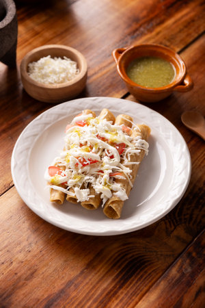 Golden tacos. Mexican dish also known as Flautas, consists of a rolled corn tortilla with some filling, commonly chicken or beef or vegetarian options such as potatoes.の写真素材
