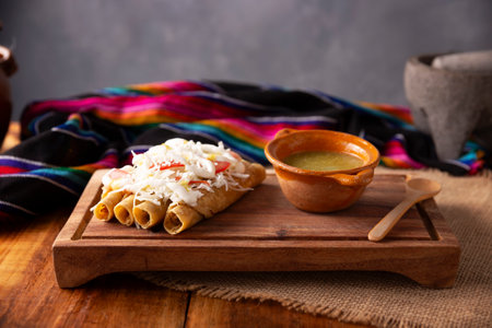 Golden tacos. Mexican dish also known as Flautas, consists of a rolled corn tortilla with some filling, commonly chicken or beef or vegetarian options such as potatoes.の写真素材