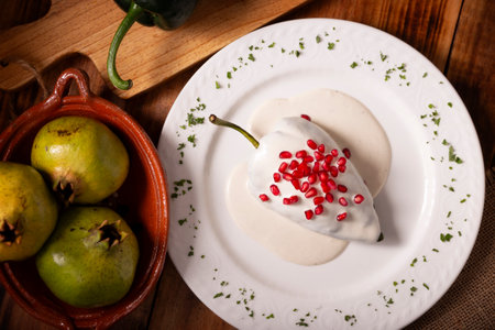 Chile en Nogada, Typical dish from Mexico. Prepared with poblano chili stuffed with meat and fruits and topped with a walnut sauce. Named as the quintessential Mexican dish for national holidays.の写真素材