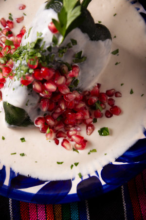 Chile en Nogada, Typical dish from Mexico. Prepared with poblano chili stuffed with meat and fruits and topped with a walnut sauce. Named as the quintessential Mexican dish for national holidays.の写真素材