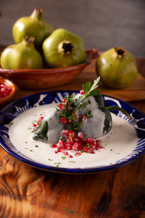 Chile en Nogada, Typical dish from Mexico. Prepared with poblano chili stuffed with meat and fruits and topped with a walnut sauce. Named as the quintessential Mexican dish for national holidays.の写真素材
