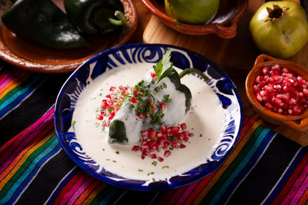 Chile en Nogada, Typical dish from Mexico. Prepared with poblano chili stuffed with meat and fruits and topped with a walnut sauce. Named as the quintessential Mexican dish for national holidays.の写真素材