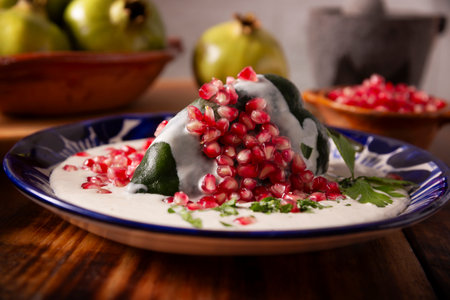 Chiles en Nogada, Typical dish from Mexico. Prepared with poblano chili stuffed with meat and fruits and topped with a walnut sauce. Named as the quintessential Mexican dish for national holidays.の写真素材