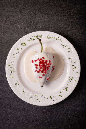 Chiles en Nogada, Typical dish from Mexico. Prepared with poblano chili stuffed with meat and fruits and topped with a walnut sauce. Named as the quintessential Mexican dish for national holidays.の写真素材