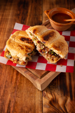 Suadero cake. Torta in Mexico is a type of sandwich that is generally made with a bread called Telera. Suadero, fried and minced meat widely used in the typical Mexican street tacos.の写真素材