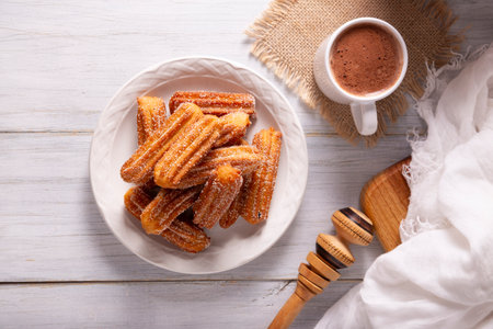 Churros. Fried wheat flour dough, a very popular sweet snack in Spain, Mexico and other countries where it is customary to eat them for breakfast or snack accompanied by hot chocolate or coffee.の写真素材