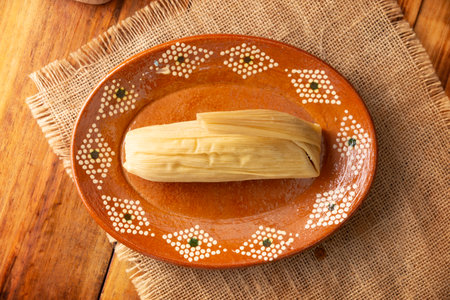 Tamales. hispanic dish typical of Mexico and some Latin American countries. Corn dough wrapped in corn leaves. The tamales are steamed.の写真素材