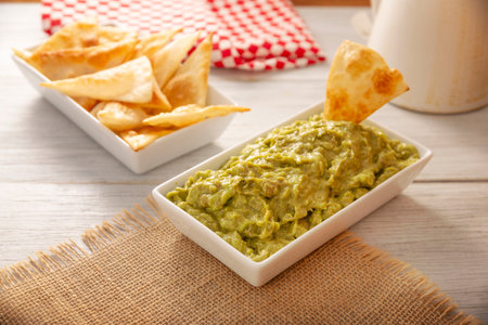Guacamole. Avocado dip sauce, one of its many ways of consuming it is spread on tortilla chips also called Nachos. Mexican easy homemade sauce recipe very popular.の写真素材