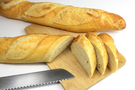 Sliced fresh baguette and bread knife