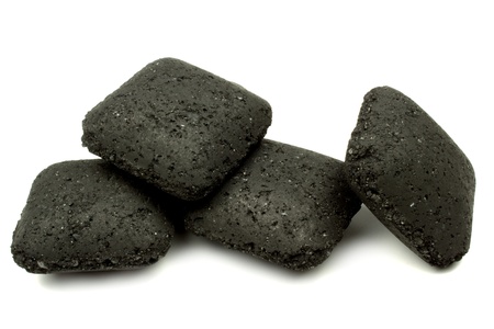 Close up charcoal briquettes on white backgroundの写真素材