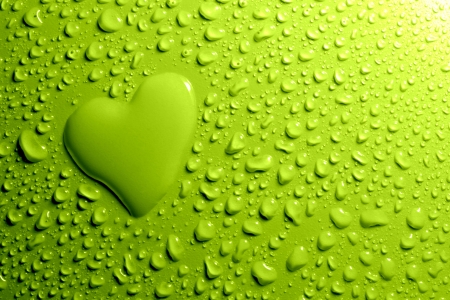 Water drops and heart shape on green backgroundの写真素材