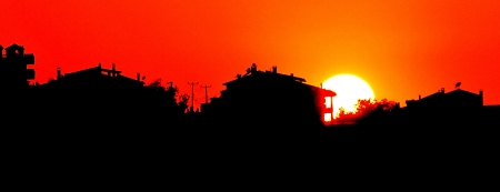 sunset with town silhouette の写真素材