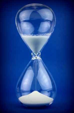 Hourglass on blue backgroundの写真素材