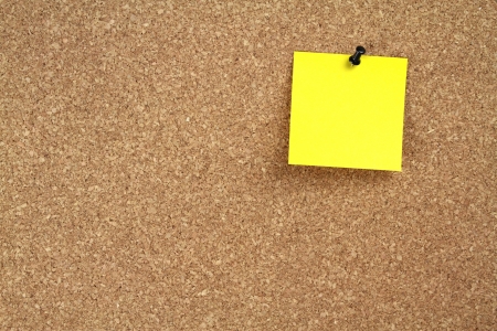 Cork notice board and  yellow note paperの写真素材