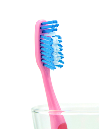 Toothbrush in glass on white backgroundの写真素材