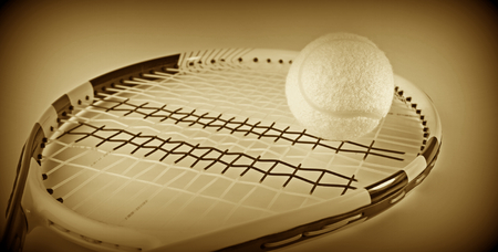 Tennis ball on a racket. Sepia vintage imageの写真素材