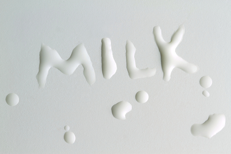 Milk drops and "MILK" text with milkの写真素材