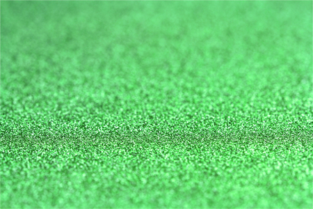 Shiny green glitter paper defocused texture background.の写真素材